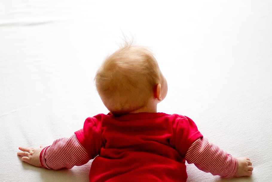 baby, wearing, red, long-sleeved, shirt, laying, white, surface, curiosity, infant