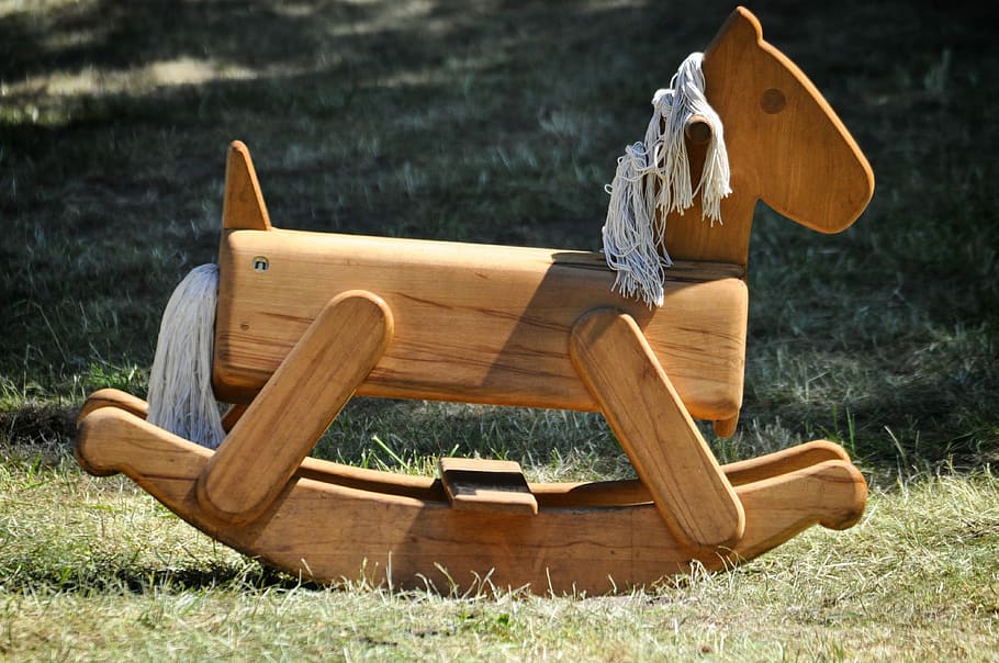 brown, rocking horse ride-on toy, grass, daytime, rocking horse, medieval market, rocking rocking horse, game device, tent city, historically