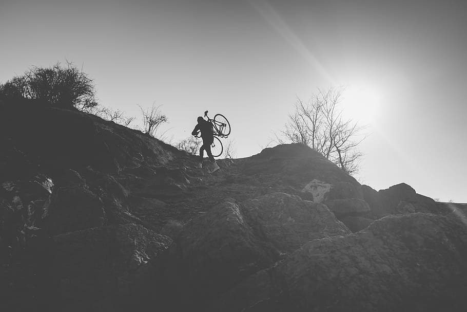 man, carrying, bike, top, mountain, grayscale, photography, person, bicycle, daytime