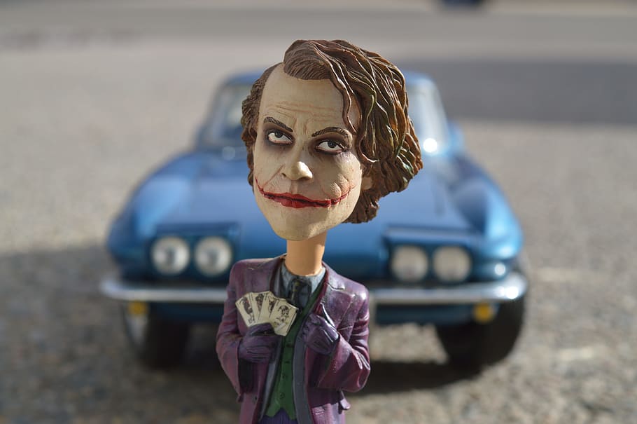 close-up photo, joker figure toy, Joker, Batman, Heath Ledger, Villain, comic, action figure, car, background