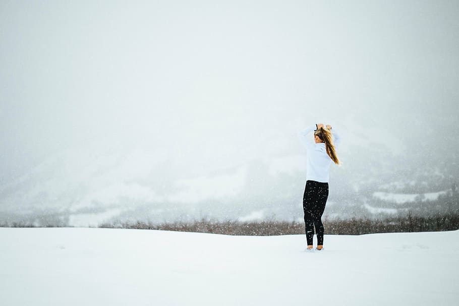 woman, white, long-sleeved, shirt, black, pants outfit, standing, middle, snow, daytime