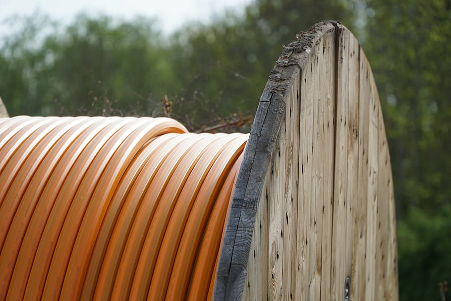 cable, cable reel, orange, rolled up, role, hose, civil engineering, wood - material, focus on foreground, tree