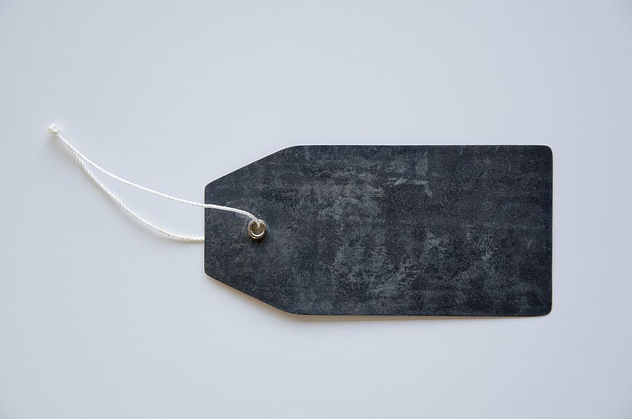 black cloth tag, tag, label, design, metal, rope, string, black, studio shot, single object