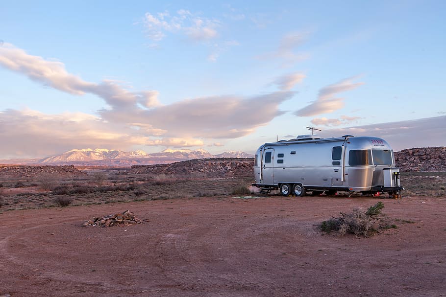 gray, camper trailer, parked, open, field, daytime, dawn, daylight, desert, hot