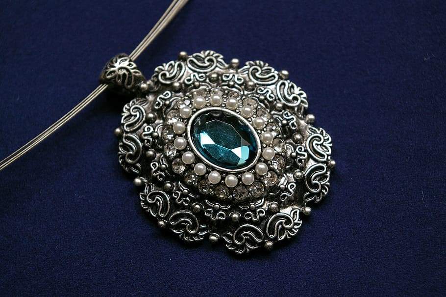 silver-colored pendant, cyan gemstone, blue, velvet textile, chain, trailers, fashion jewelry, jewellery, decorative, shiny