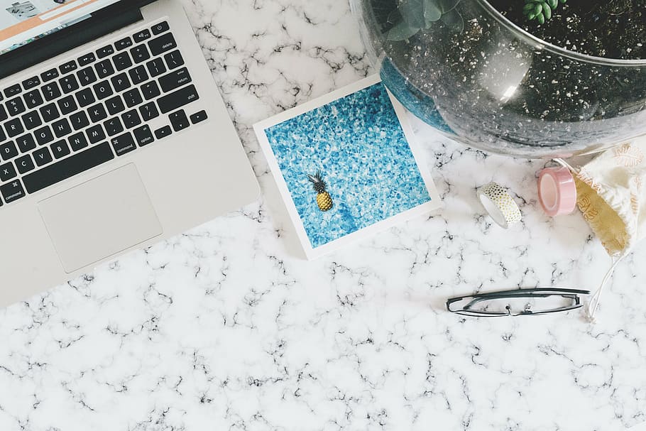 flat, lay, photography, macbook, pineapple card, black, framed, eyeglasses, white, marble surface