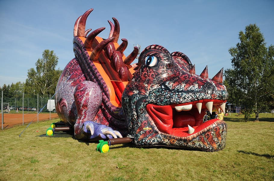 bouncy castle, inflatable slide, dragons, children's playground, fun, play, game device, play outside, sky, representation
