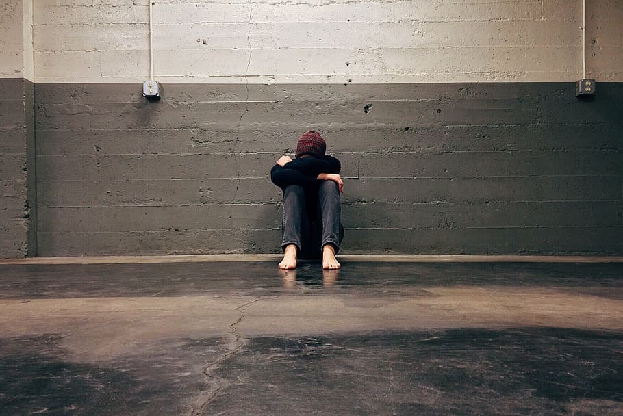 person, sitting, floor, leaning, gray, concrete, wall, homeless, bullied, hiding