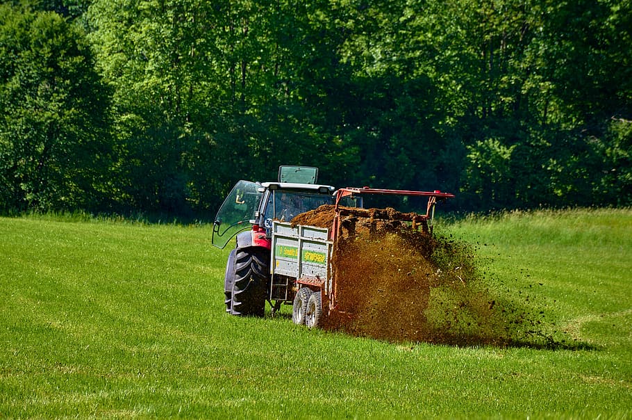 Tractor fertilizing lawn