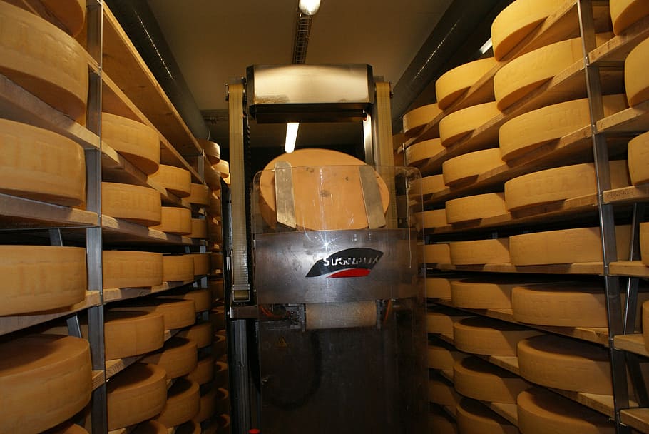 cheese storage, cheese, cheese dairy, indoors, wood - material, shelf, building, architecture, warehouse, cellar