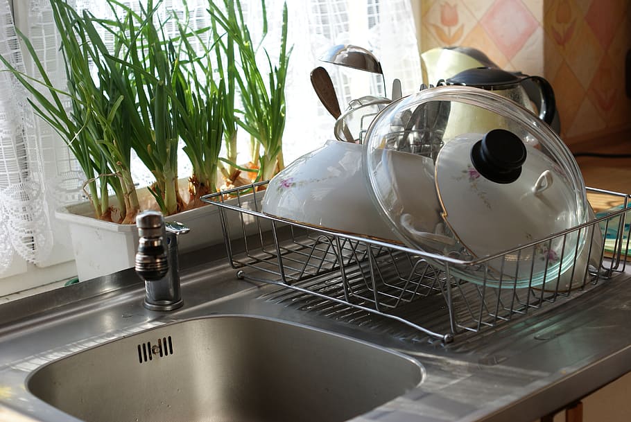 dishes, dish rack, sink, kitchen, faucet, metal, kitchen utensils, indoors, household equipment, plant