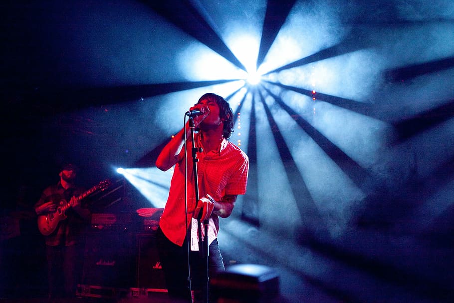 man using microphone, man, wearing, red, dress, shirt, singing, spotlight, music, studio