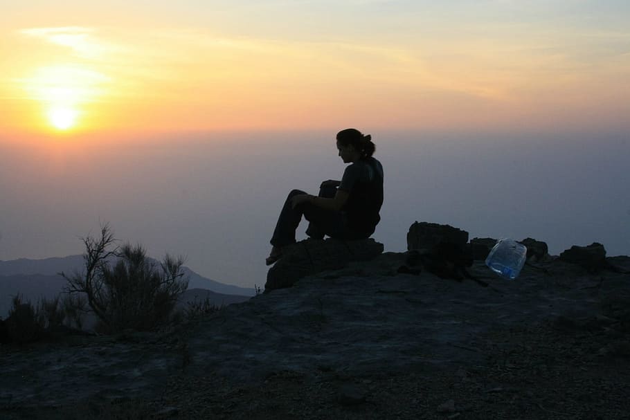 person, sitting, stone, watching, sunset, sunrise, silhouette, nature, sky, sun