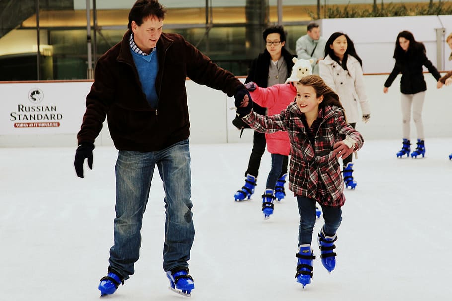 man, holding, girl, white, wearing, inline skates, skates, ice, father and daughter, rink