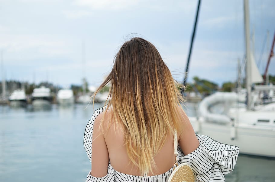 woman, white, black, stripe off-shoulder blouse, standing, docking pier, speed boat, yacht, boat, travel