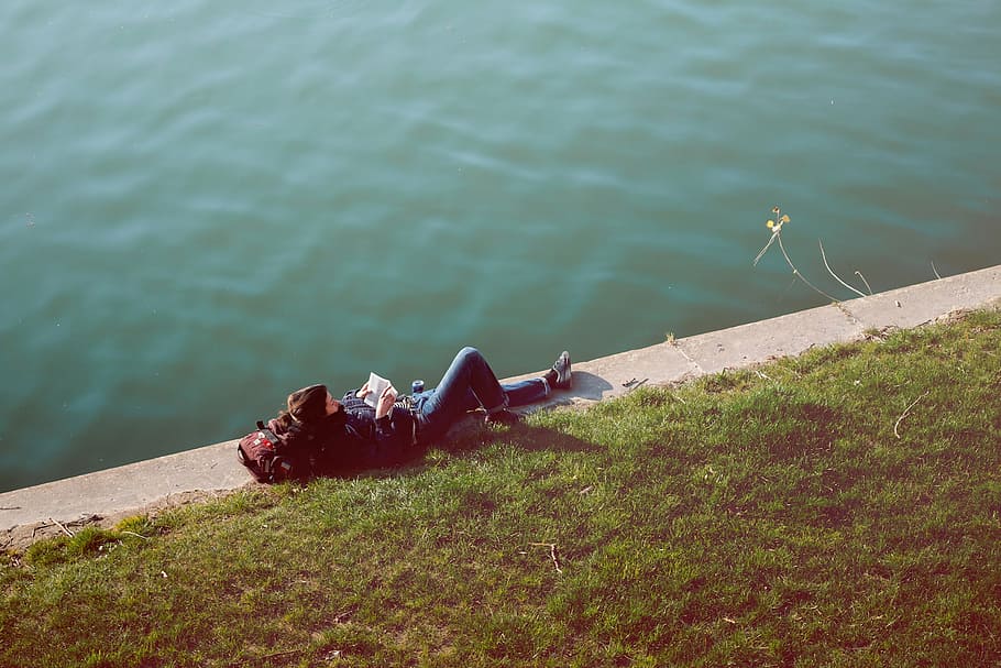 person, laying, body, water, nature, grass, people, man, guy, reading