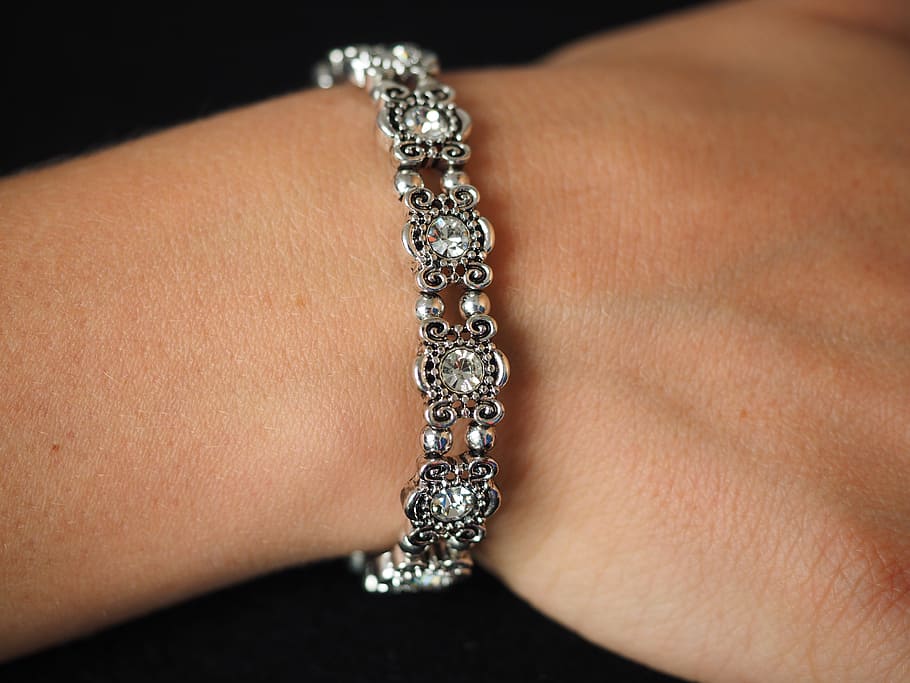 person, wearing, silver-colored bracelet, bracelet, bangle, jewellery, silver, diamonds, gems, valuable