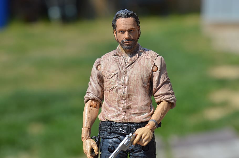 man, wearing, red, button-up dress shirt, holding, revolver figure, the walking dead, rick grimes, action figure, tv