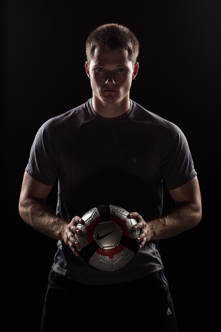 man, wearing, gray, crew-neck t-shirt, holding, black, nike soccer ball, soccer, sports, model