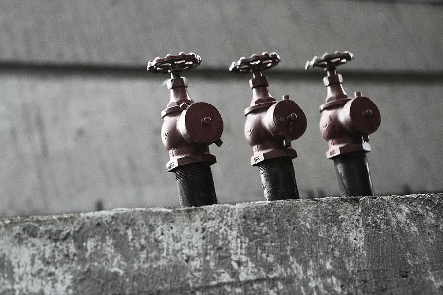grayscale photography, spigots, three, brown, metal, gate, valves, close, fire hydrant, sprinklers