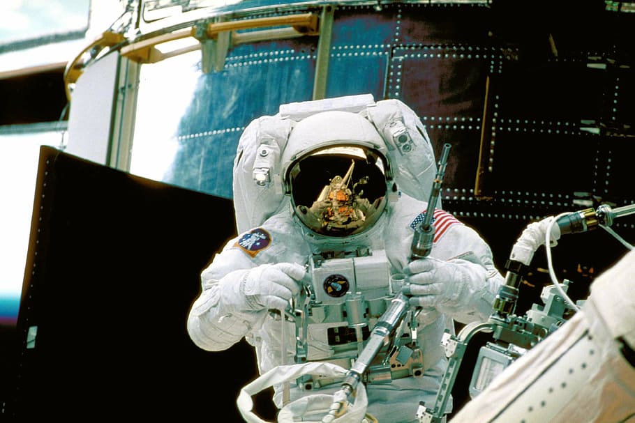astronaut holding equipment, astronaut, space-suit, space, nasa, aerospace, outer space, space walk, mode of transportation, transportation