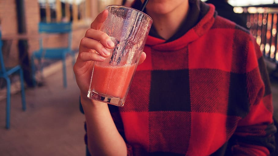 person, holding, clear, drinking glass, girl, teen, tartan, student, hoodie, smoothie