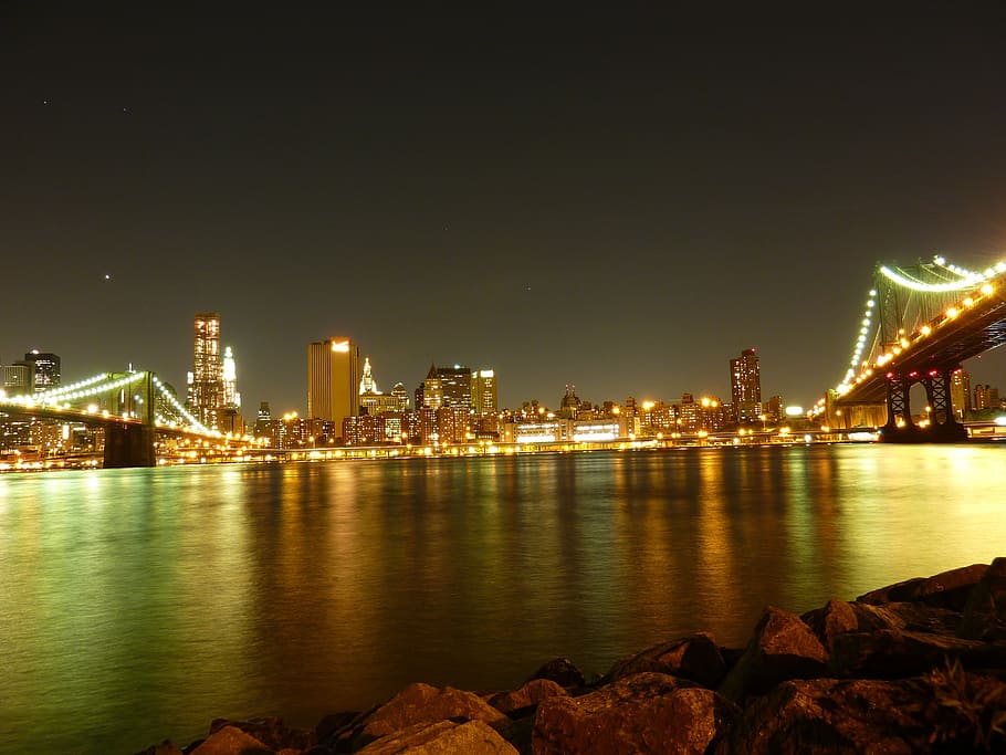 rocks, calm, water, city buildings, golden, lights, nighttime, new york, ny, nyc