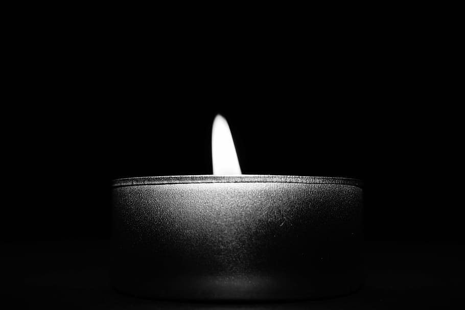 grayscale photography, lighted, candle, black, white, light, dark, black and white, night, flame