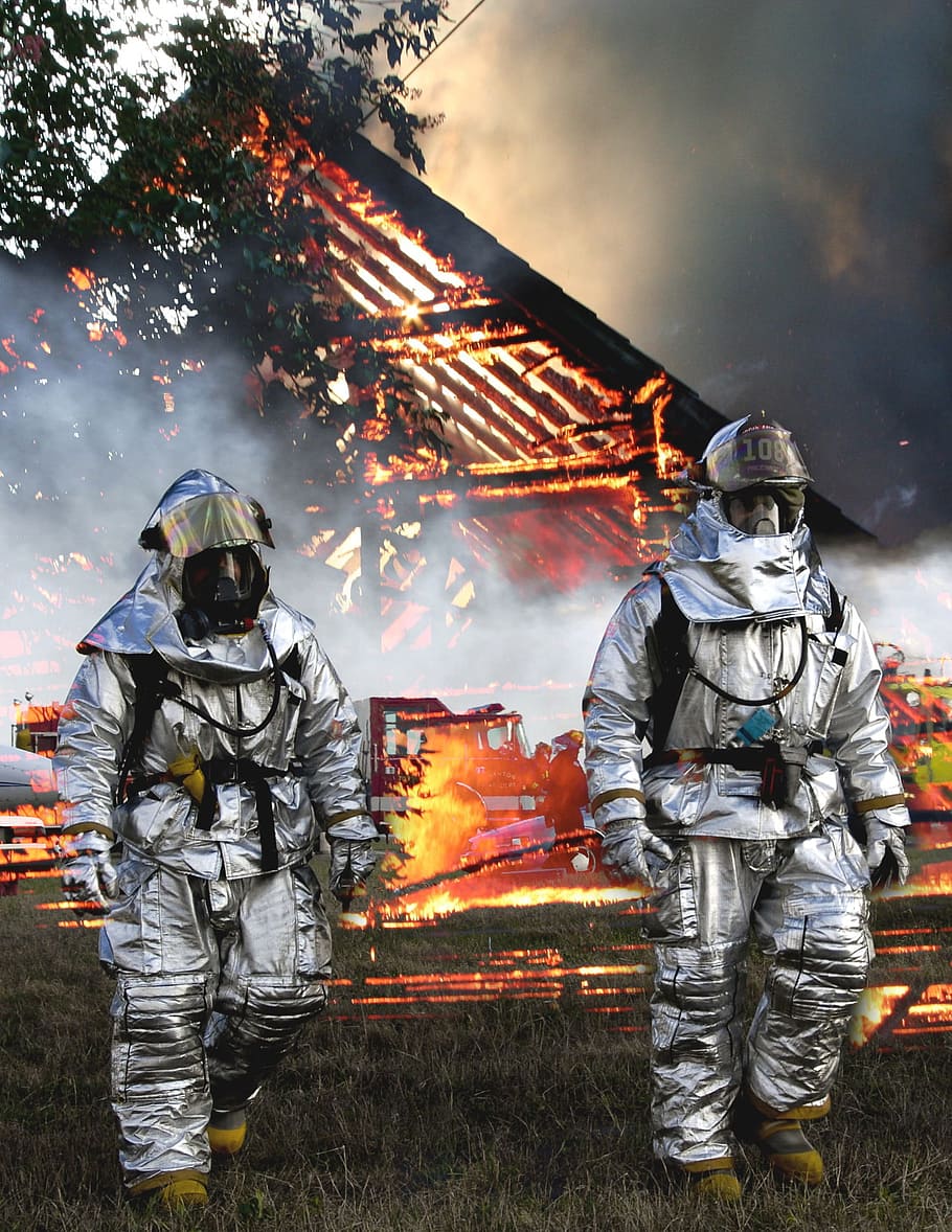 two, fireman, walking, grass, burning, fire house, back, walking on, house at the back, fire