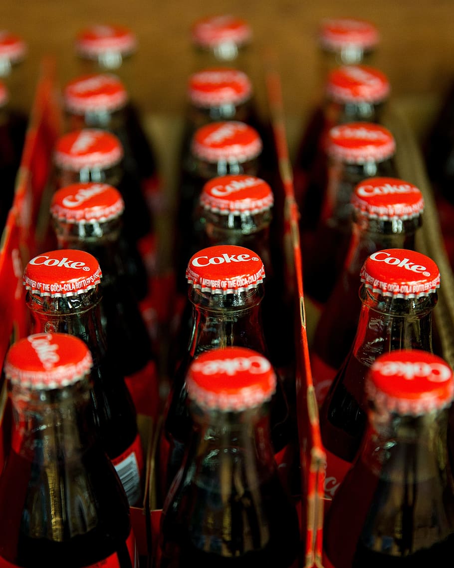 close-up photo, coke soda bottles, coca cola, coke, bottles, soda, softdrink, indoors, close-up, in a row
