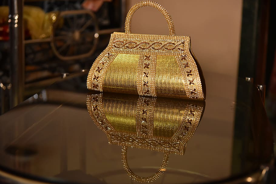 golden, indian wedding, purse accessory, art and craft, indoors, store, hanging, still life, close-up, reflection
