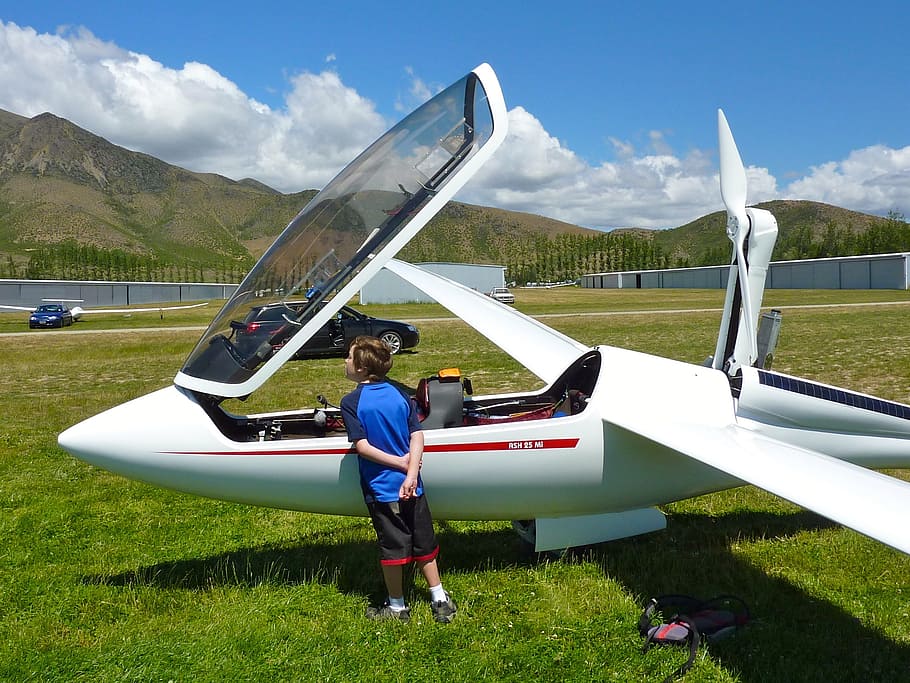 glider, child, flight, dream, real people, full length, one person, grass, transportation, leisure activity