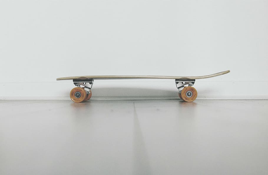 brown, black, skateboard, cruiser, board, near, white, wall, still, items