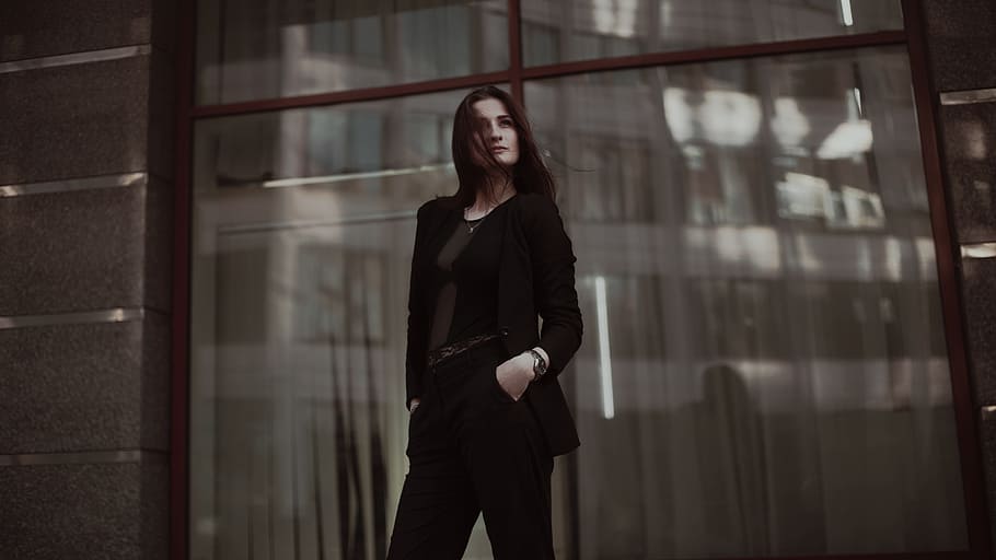 selective, focus photography, woman, black, scoop neck longsleeve, pants, standing, behind, clear, glass wall