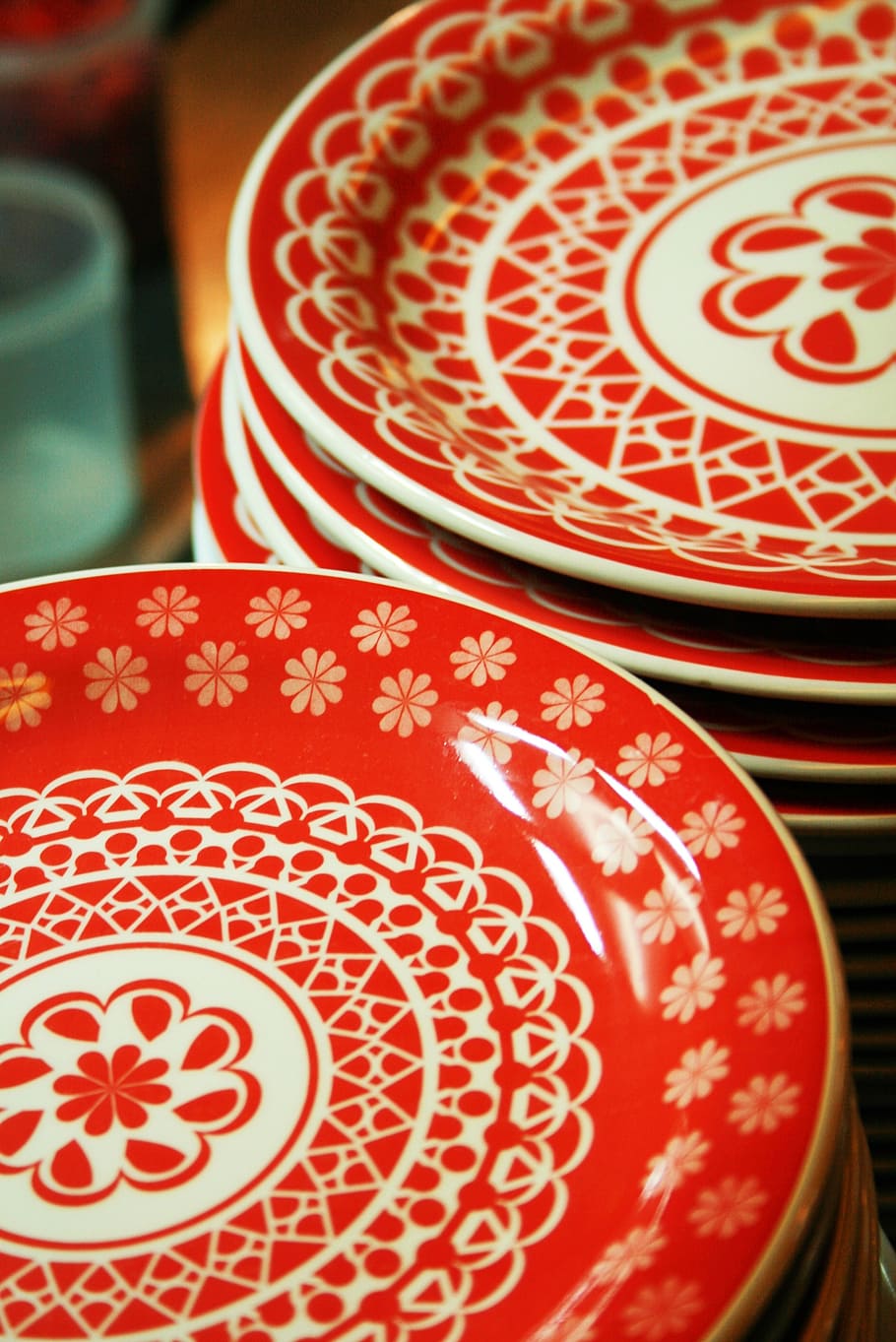 plate, glyph, container, red, pattern, close-up, indoors, focus on foreground, still life, non-western script