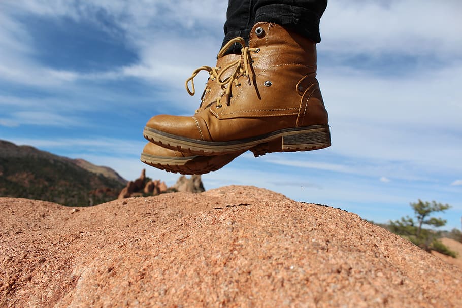 person, wearing, brown, leather cap-toe, chunky, heel combat boots, jumping, soil, feet, boots