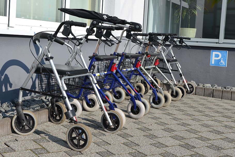 closeup, lined, white-and-blue rollators, gray, painted, wall, rollator, seniors, disabled parking space, walking aids