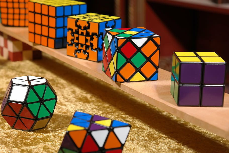 assorted-color-and-shape rubik, cube lot, shelf, magic cube, patience games, puzzle, tricky, toys, puzzle piece, play