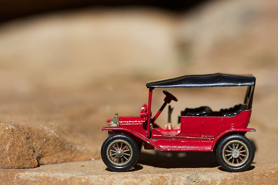 toy car, red, automobile, small, mode of transportation, transportation, land vehicle, focus on foreground, toy, car