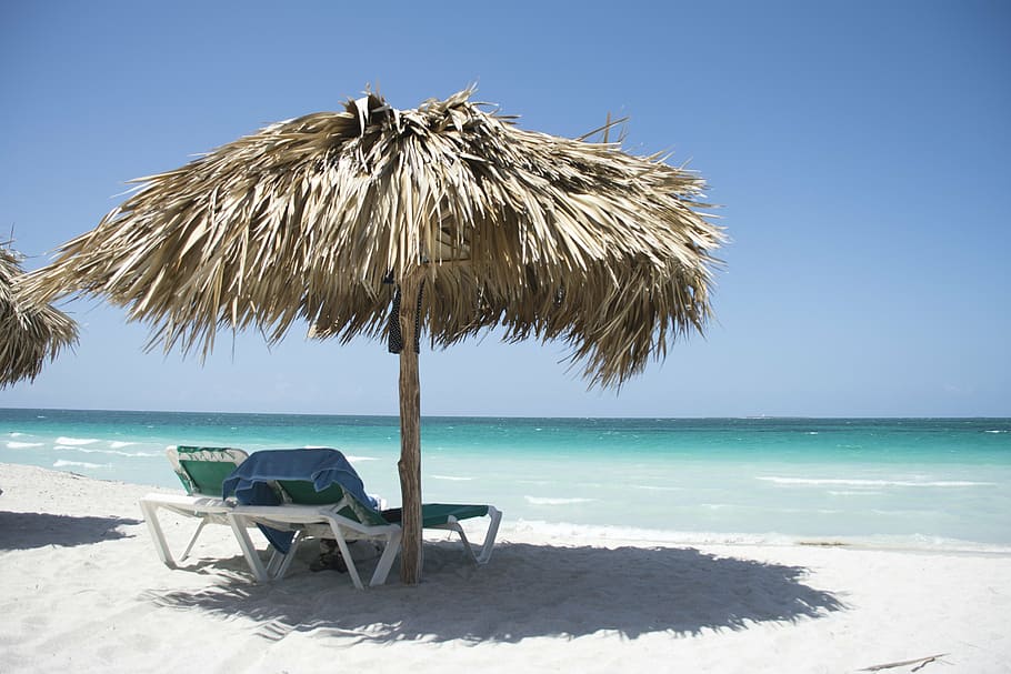 two, white, loungers, brown, hut, front, sea, daytime, cuba, beach