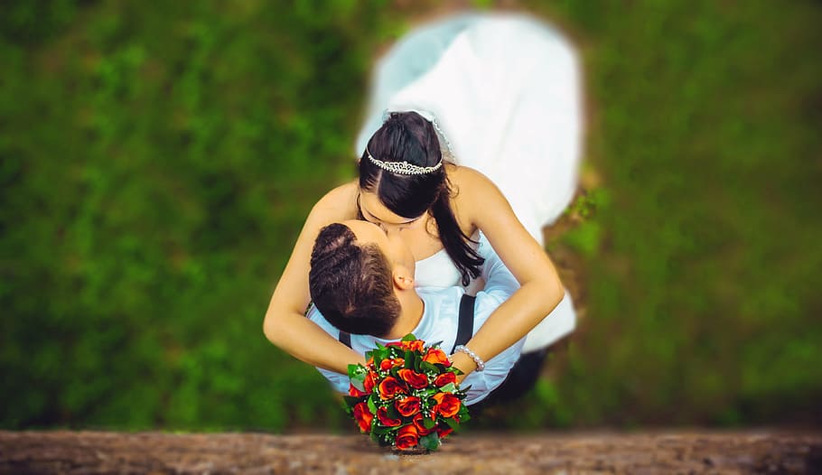 woman, holding, red, rose, bouquet, kissing, man, wedding, grooms, embracing each other