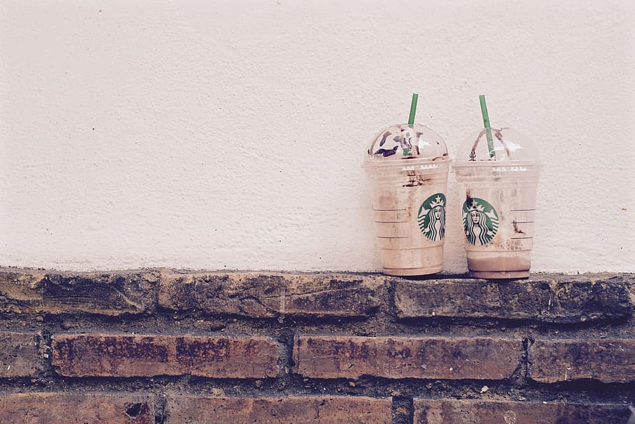 two, empty, disposable, cups, wall, near, plastic, Starbucks, coffee, drinks