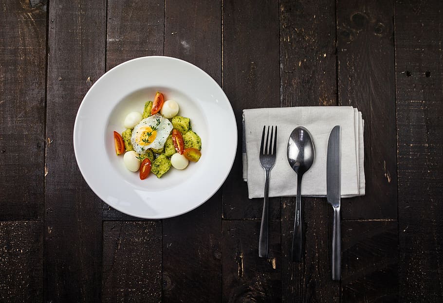 egg, vegetable, plate, cutlery, table, salad, wooden, napkin, tissue, paper