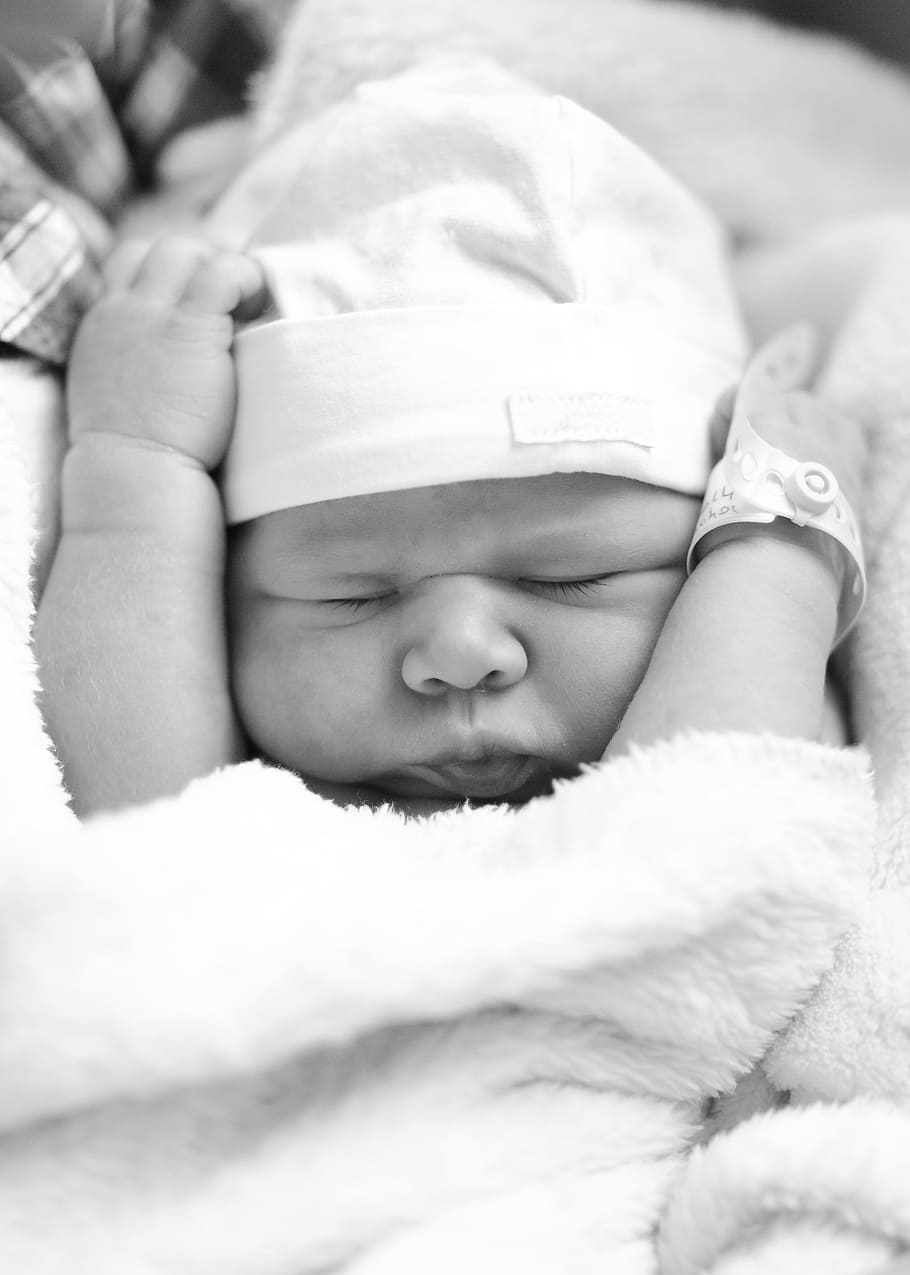 grayscale photo, newborn, baby, closing, eyes, grayscale, knit cap, amour, child, cute
