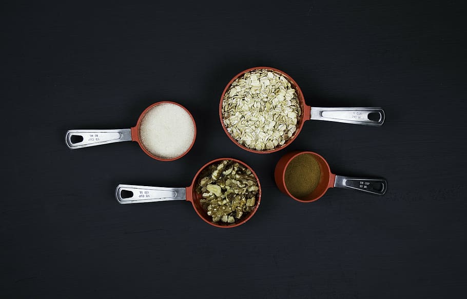 filled, four, measuring, spoons, kitchen, kitchen tool, kitchen utensil, oatmeal, pecans, red