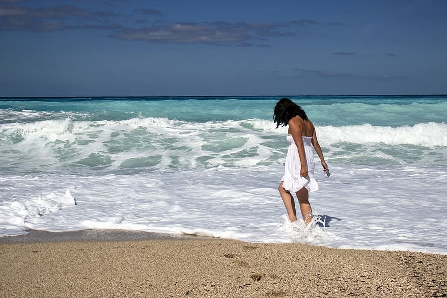 woman, white, tube flare mini dress, walking, seashore, blue, sky, daytime, woman in white, tube