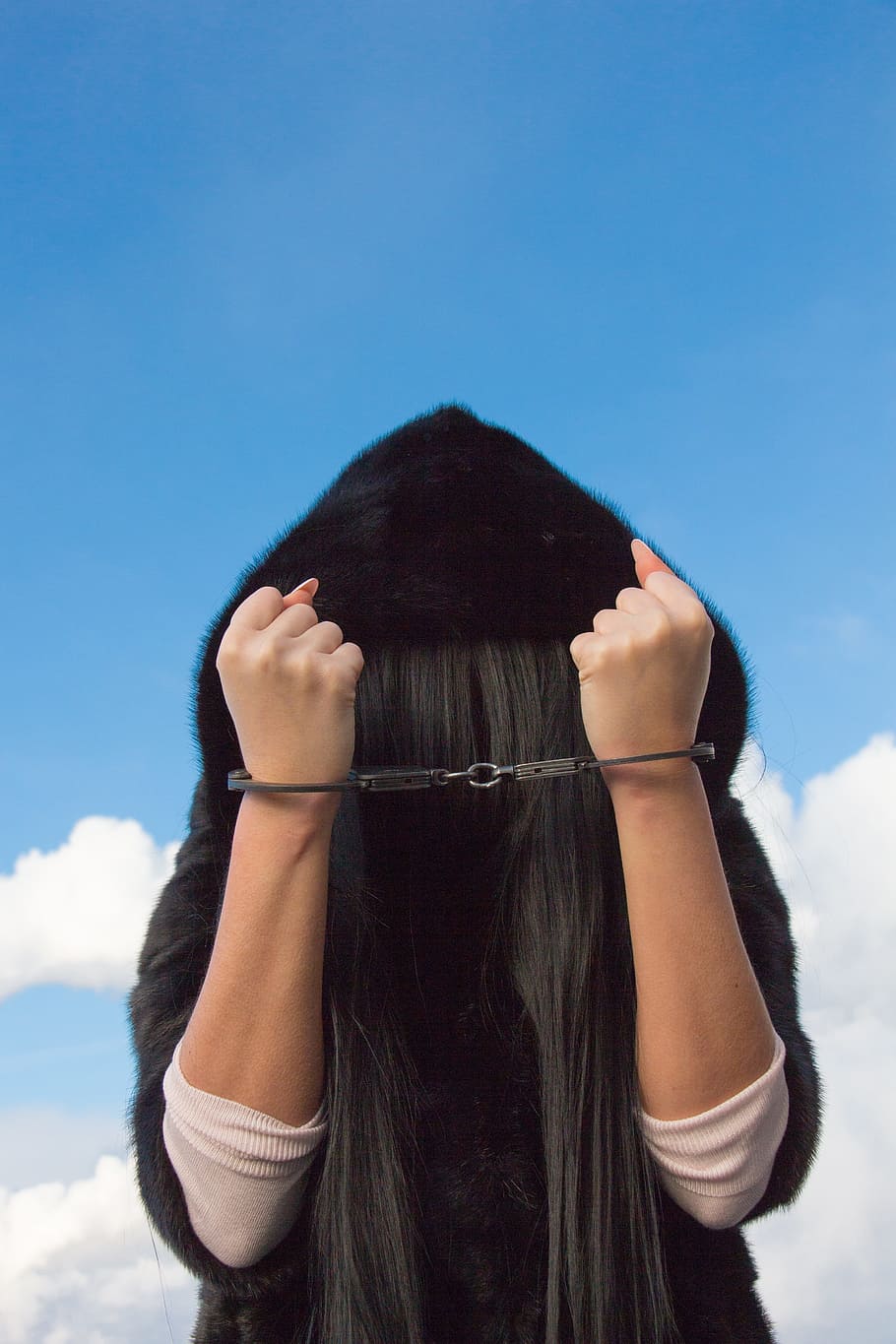 woman, wearing, black, fur hoodie, hand, handcuffed, fur, hoodie, the dependence of, women's dependence