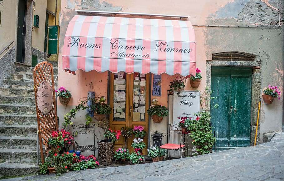 pink, white, stripe awning, rooms camere limmer text, italy, cinque terre, store front, awning, flowers, shop
