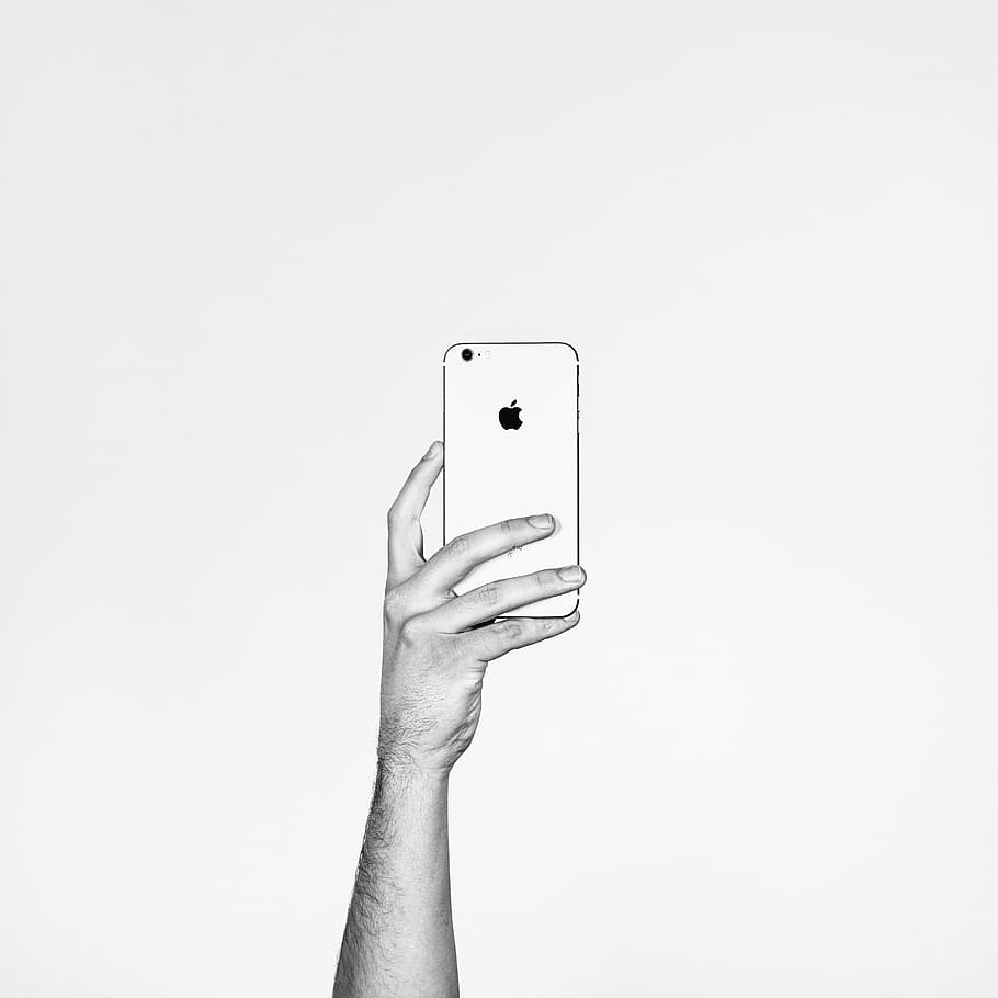 grayscale photography, person, holding, iphone, mobile, apple, electronic, gadget, modern, technology