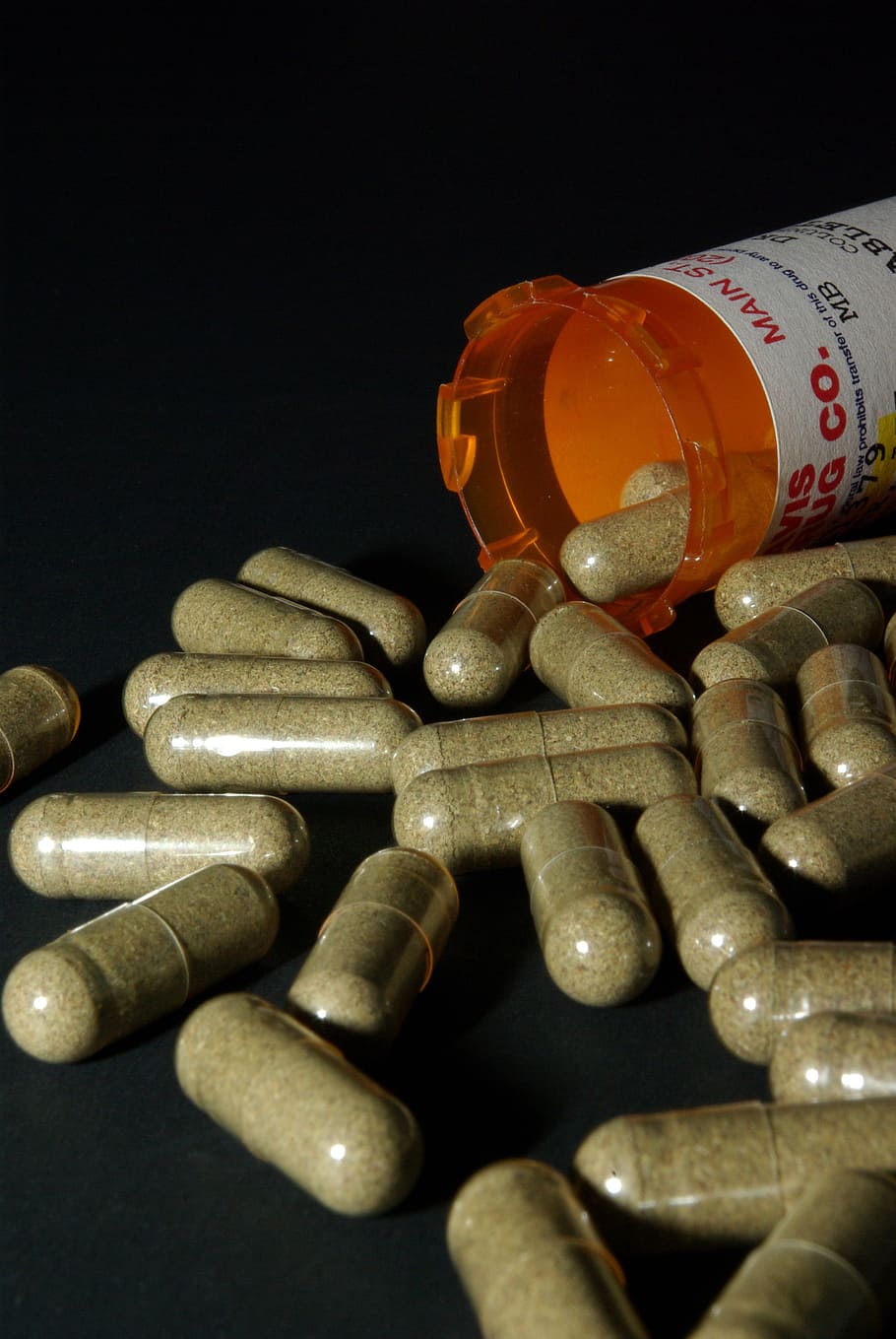medication capsules, spilling, orange, prescription bottle, black, surface, medicine, medical, health, drugs